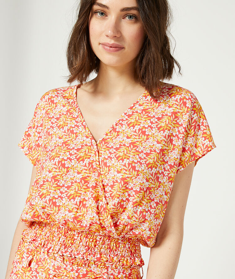 Smocked top in a floral print coral.