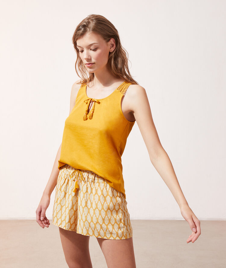 D&eacute;bardeur &agrave; pompons ocre.