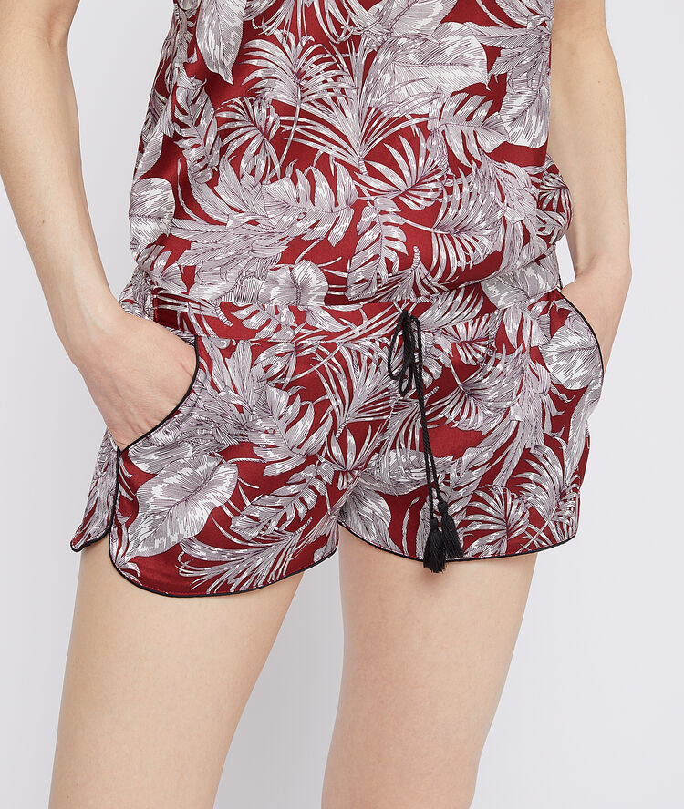 Leaves print shorts brick red.
