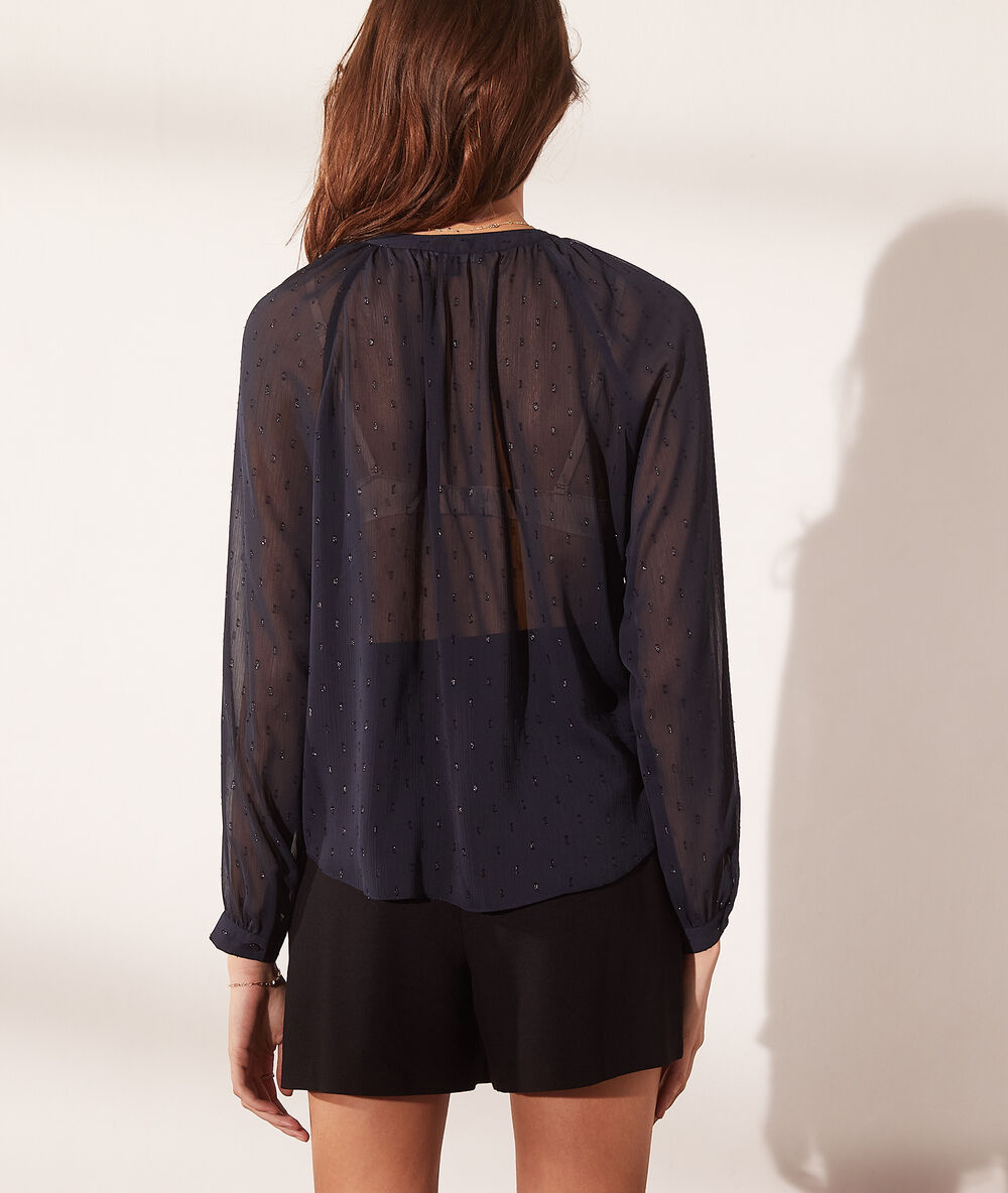 Blouse transparente avec paillettes bleu marine.