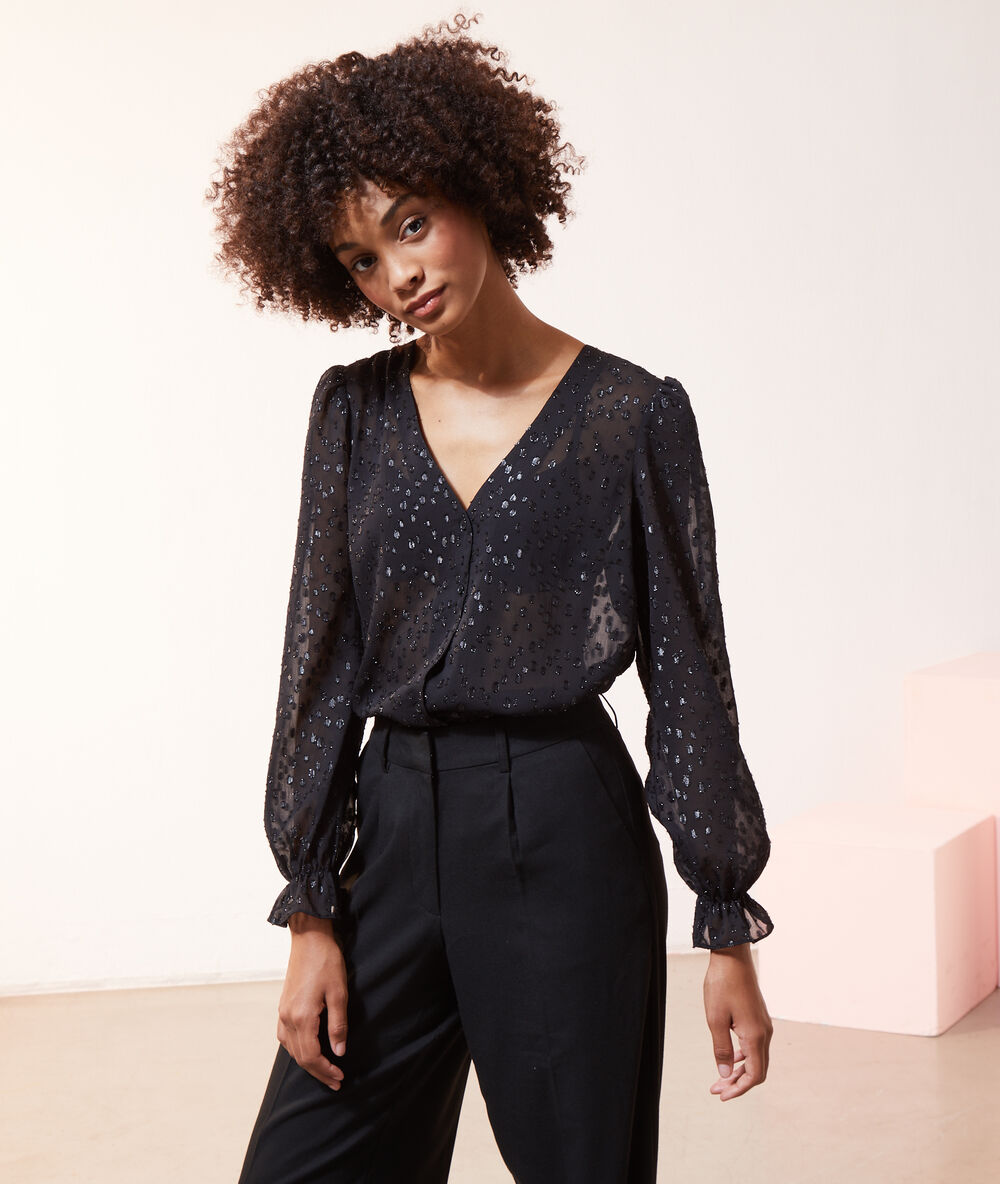 Chemise transparente paillet&eacute; manches ballon noir.