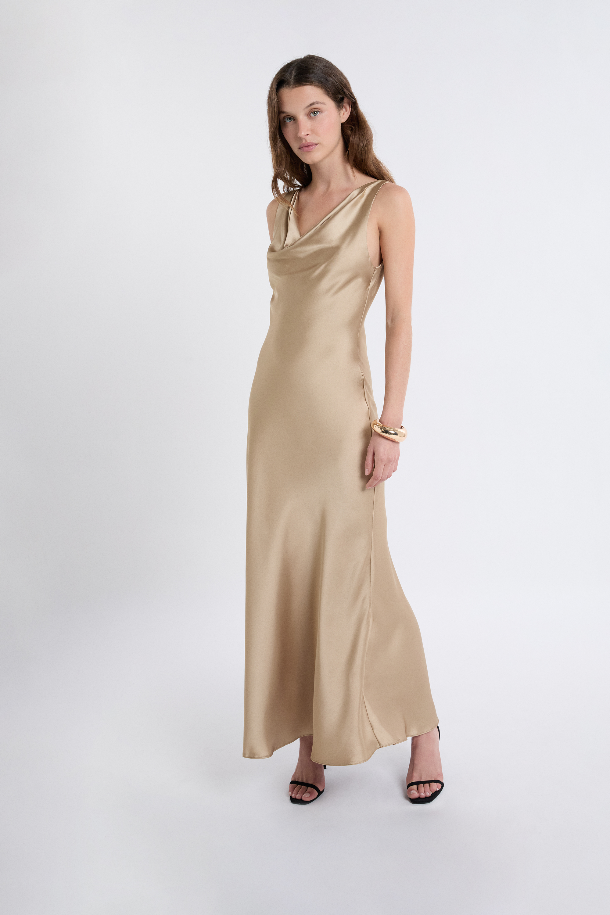 elin satin evening dress The Elin Dress  A gold crepe satin gown with an asymmetric one-shoulder  neckline and fitted waist, finished with a floor-length silhouette and  draped ruffled scarf